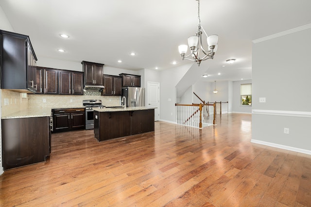 a vacant home with an open-concept living room and kitchen with hardwood floors connecting the rooms