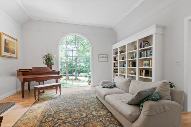 living room with a large picture window, white bookcase, and a brown piano.jpeg